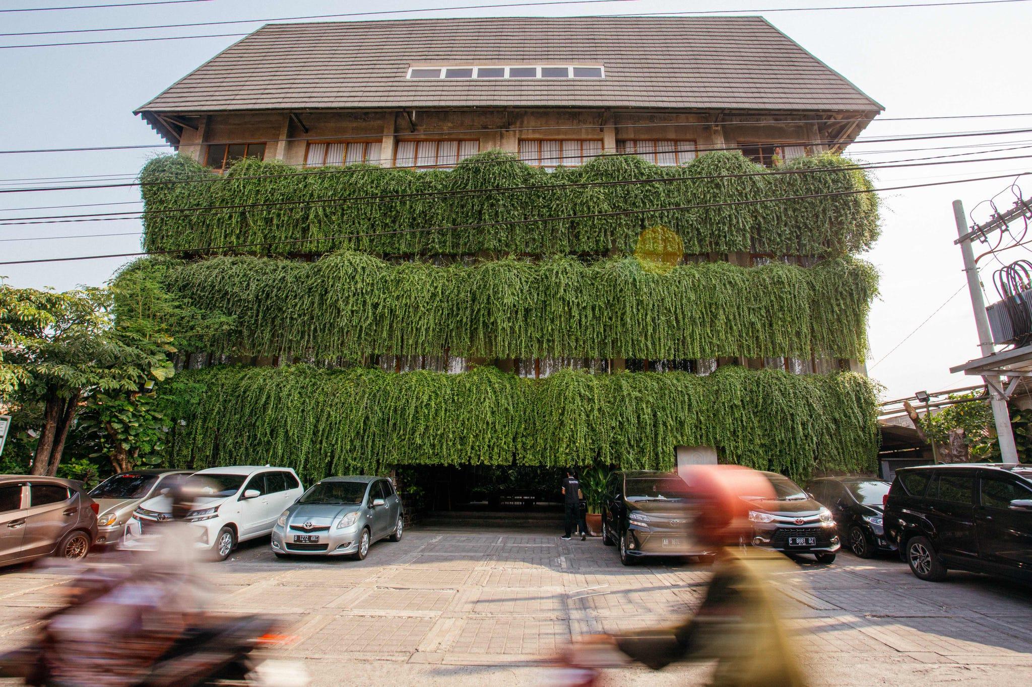 un bâtiment avec une haie sur le toit