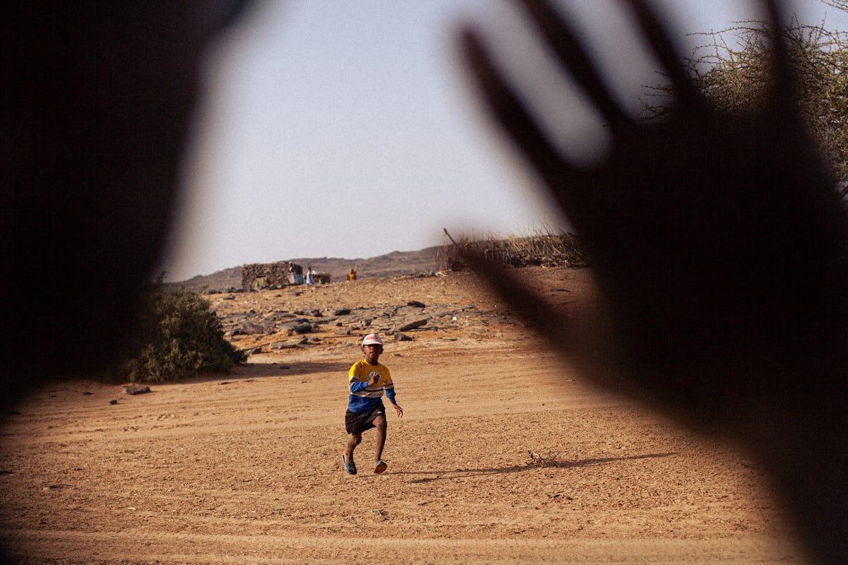 une personne courant sur une route en terre