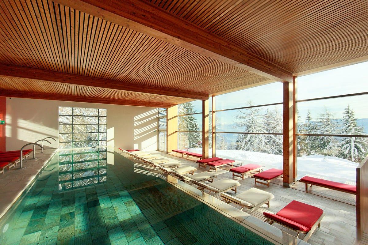 a room with a pool and benches